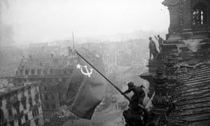 Red army soldiers raising the Soviet flag over the Reichstag in Berlin on 30 April 1945.